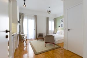 a bedroom with a bed and a desk with a chair at Dinostratus House in Athens