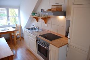 een keuken met een spoelbak en een fornuis bovenste oven bij Schillers Gästehaus in Hitzacker