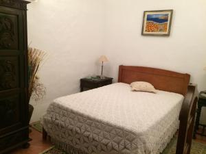 a bedroom with a bed and a table with a lamp at Ninho das Perdizes - Monte Novo in Cercal +19 photos