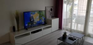 a living room with a flat screen tv on a entertainment center at Palm beach Cannes Azur in Cannes