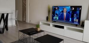 a living room with a flat screen tv on a wall at Palm beach Cannes Azur in Cannes