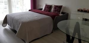 a bedroom with a bed with a glass table at Palm beach Cannes Azur in Cannes