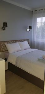 a bedroom with a bed with two lamps and a window at Palm beach Cannes Azur in Cannes