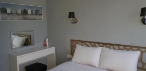 a bedroom with a bed with a fireplace and a mirror at Palm beach Cannes Azur in Cannes