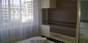 a bedroom with a window and a bed with a towel at Palm beach Cannes Azur in Cannes