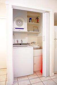 a kitchen with a sink and a microwave at Villa 15 Tangalooma Resort in Tangalooma
