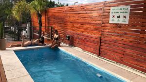 
a man is sitting in a pool of water at Carlos Paz Hostel&Suites in Villa Carlos Paz
