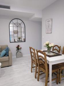 a living room with a table and chairs at Apartamento centro san blas 36, próximo al Pilar in Zaragoza