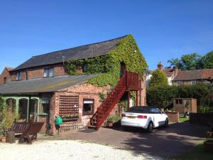 a house with a car parked in front of it at RolandsCroft Guest House in Pontefract