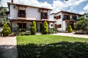 a house with a lawn in front of it at Iliahtides in Kala Nera