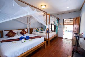 a bedroom with two beds in a room at Lipe Beach Resort in Ko Lipe