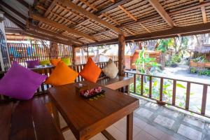 a room with a table and chairs and a balcony at Lipe Beach Resort in Ko Lipe
