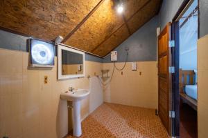 a bathroom with a sink and a shower and a window at Lipe Beach Resort in Ko Lipe