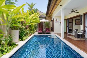 a swimming pool in the middle of a villa at Kubu Gajah Villas in Sanur