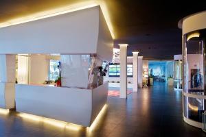 a lobby with a white counter in a building at Panoramic Hotel Plaza in Abano Terme