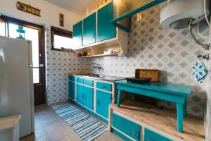a kitchen with blue cabinets and a blue table at Lisboa Manaia Home in Lisbon