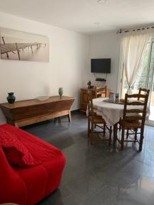 a living room with a table and a couch at Appart'Hôtel Les Rochers in Auriol