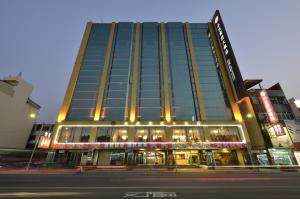 a tall building with lights on the side of a street at Ever Delightful Business Hotel in Chiayi City