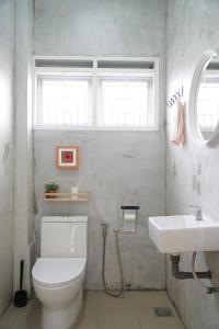 a bathroom with a white toilet and a sink at In Homs 26 in Klang