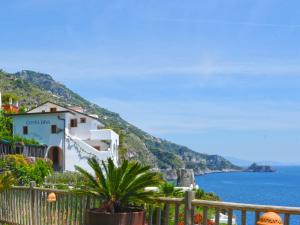 a house on a hill next to the ocean at Hotel Costa Diva in Praiano