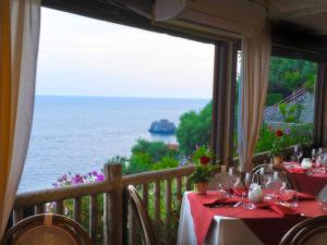 a dining room with a view of the ocean at Hotel Costa Diva in Praiano