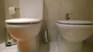 un bagno con un water bianco e un rotolo di carta igienica di Marginal Luminous Beach Apartment a Vila do Conde Altre 29 foto