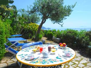 a table with food on it with a view of the ocean at Hotel Costa Diva in Praiano