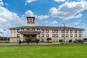 a large building with a clock tower on top of it at Sleep Inn & Suites Norman near University in Norman