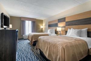 A bed or beds in a room at Quality Inn & Suites Lafayette I-65