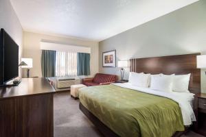 A bed or beds in a room at Quality Inn & Suites West