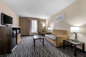 a hotel room with a couch and a tv at Quality Inn & Suites Lafayette I-65 in Lafayette