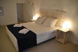 a bedroom with a large bed with two night stands at Kastro in Parikia