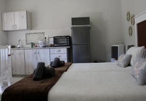 a large bed in a room with a kitchen at Tranquility Self Catering in Lüderitz