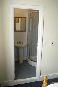 a bathroom with a shower and a sink at Grafton House in Leicester