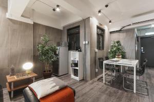 a living room with a refrigerator and a table at L'Escale in Hong Kong