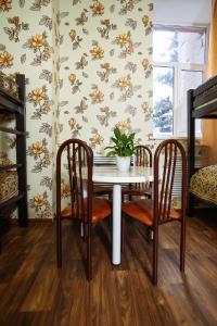 a dining room with a table and two chairs at Hostel Comfort in Yoshkar-Ola