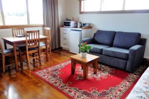 a living room with a couch and a table at Haven on Glenaven B&B in Motueka
