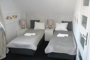 a bedroom with two beds and two night stands at Drukarnia Smaku in Oława