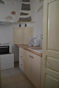 a kitchen with white cabinets and a counter top at Kastro in Parikia
