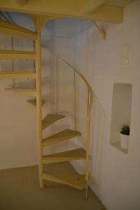 a wooden staircase in a room with a bunk bed at Kastro in Parikia