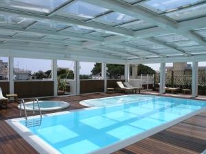 a swimming pool on the roof of a building at Aparthotel England in Riccione