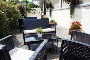 a group of chairs and tables on a patio at The Manian in Kilgetty
