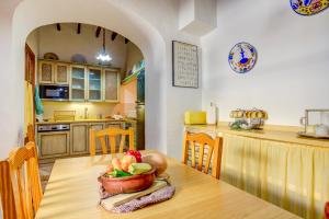 a kitchen with a table with a bowl of fruit on it at Casa Coll by Sealand Villas in Pollença