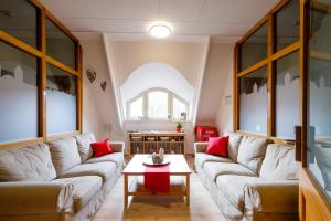 a living room with two couches and a table at Jugendherberge Youth Hostel Rothenburg Ob Der Tauber in Rothenburg ob der Tauber