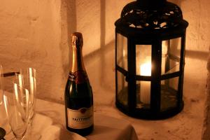 a bottle of wine sitting next to a lantern at Brunsbo G:a Biskopsgård Hotell & Konferens in Skara