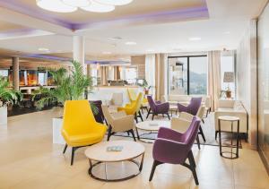 a waiting room with colorful chairs and tables at Hotel Adria in Dubrovnik