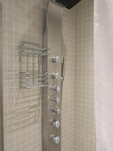 a shower with a metal door with a basket on it at ApartmentInCopenhagen Apartment 427 in Copenhagen