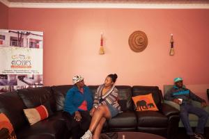 a group of people sitting on a couch at Flossie B&B in Pimville