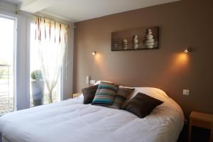 A bed or beds in a room at Logis Hotel Belle-Vue