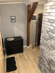 a living room with a brick wall and a table at Apartament Sunset in Sopot